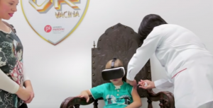 Child getting injection and wearing a VR headset